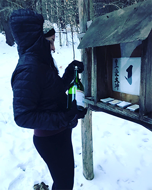 Carrie Anne Palmieri makes an offering of sake to the kamis.