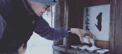 Alley Smith makes offerings at one of Karmê Chöling's Kami Shrines.